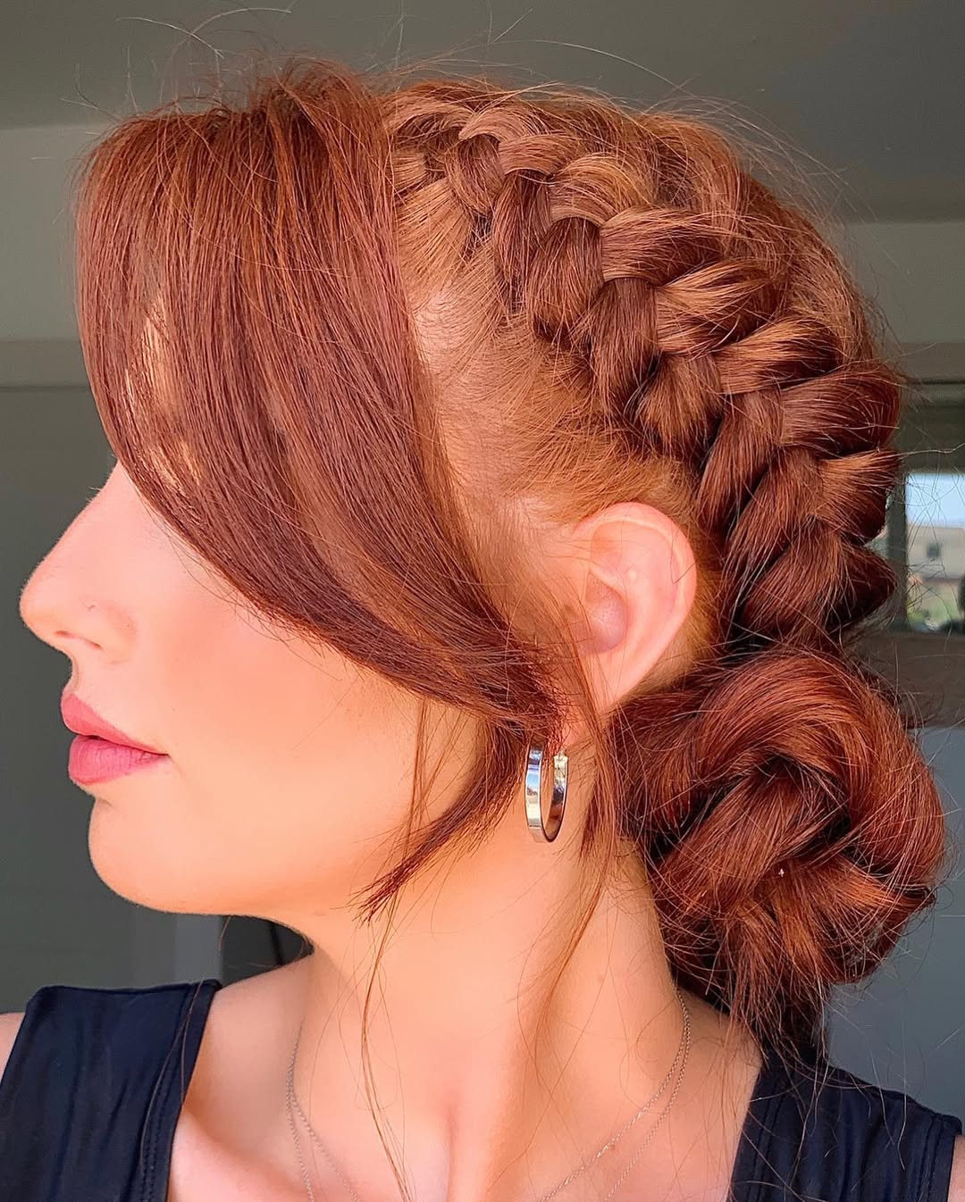 Woman with a chic messy bun, perfect for summer hairstyles hot weather, in a beige linen dress, enjoying a sunny day outdoors. Focus on comfort and style.