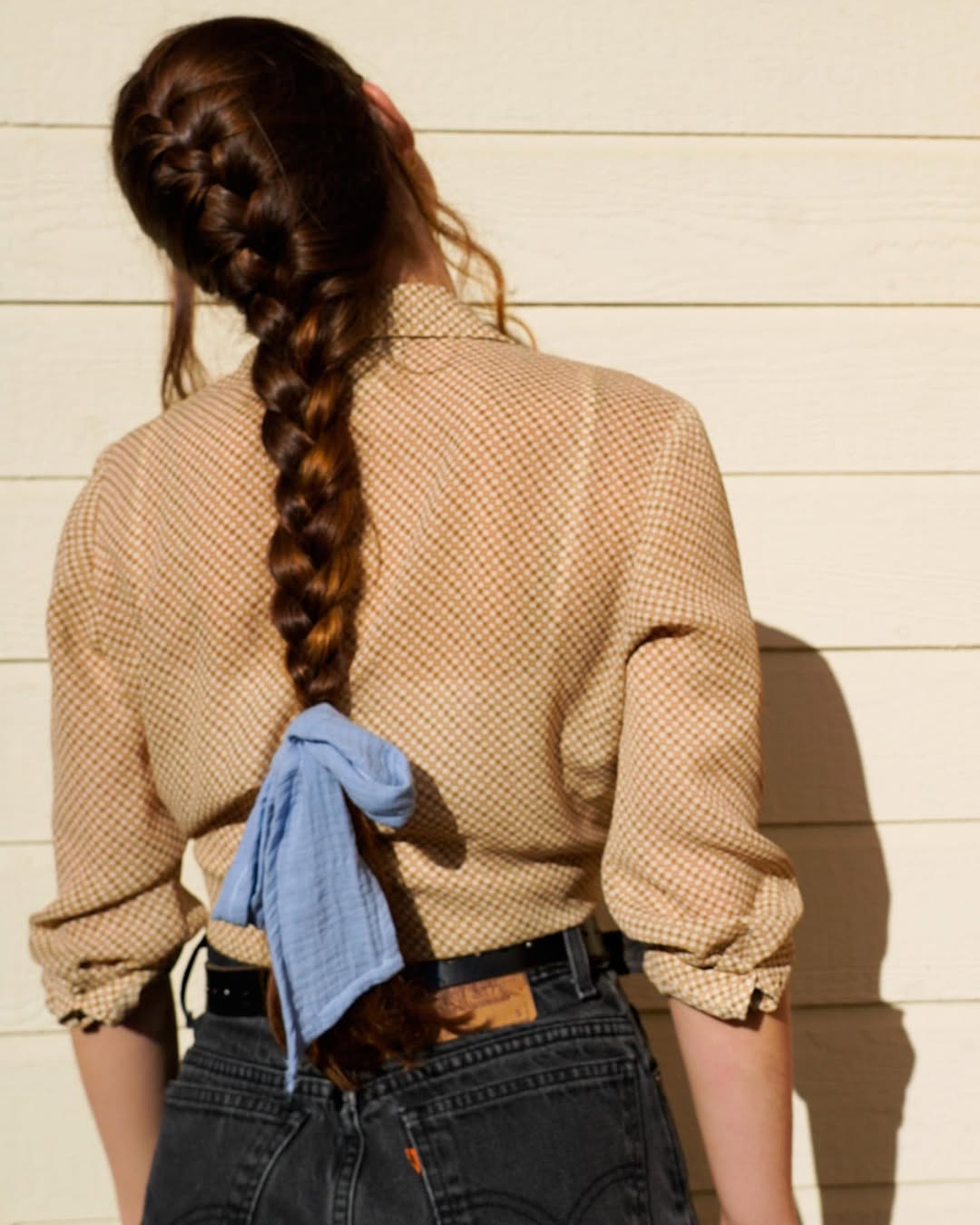 Cute Braided Teen Hairstyles Summer 2026 Teenager with braided pigtails and loose waves, perfect for teen hairstyles summer 2026. This casual, bohemian look features sun-kissed hair, ideal for beach days or outdoor festivals.