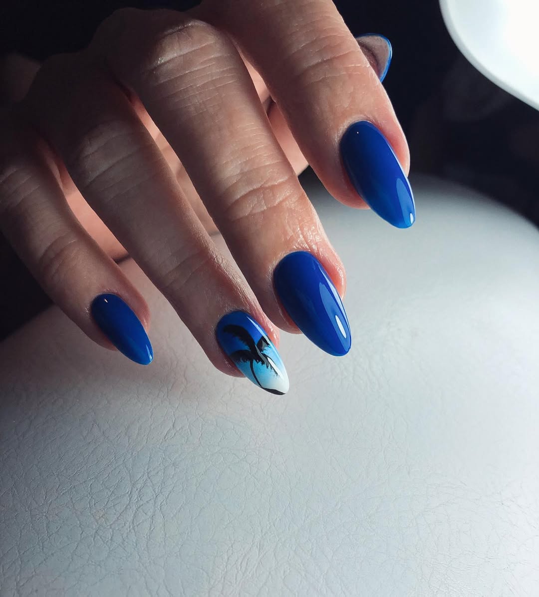 Vibrant Blue Almond Nails with Sunset Palm Art