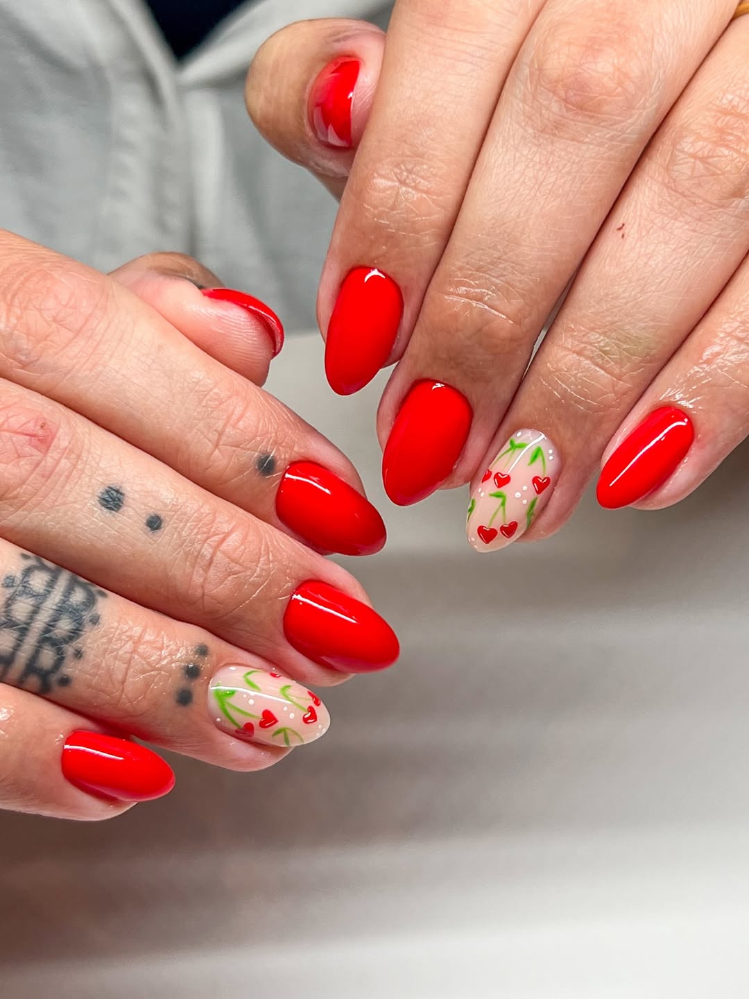 Vibrant Cherry Red Nails With Whimsical Heart Detail