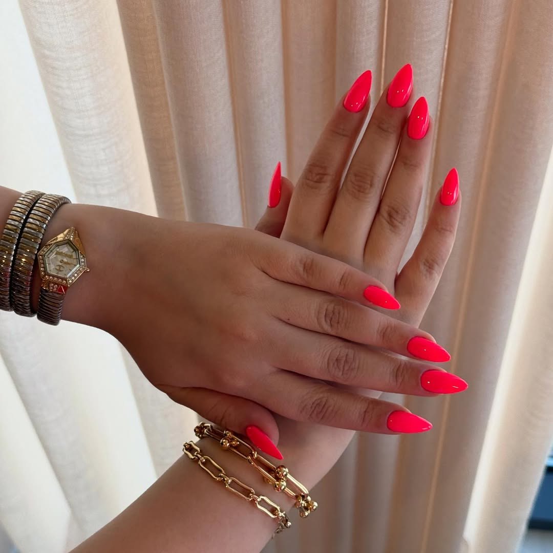 Vibrant Neon Pink Glossy Stiletto Manicure