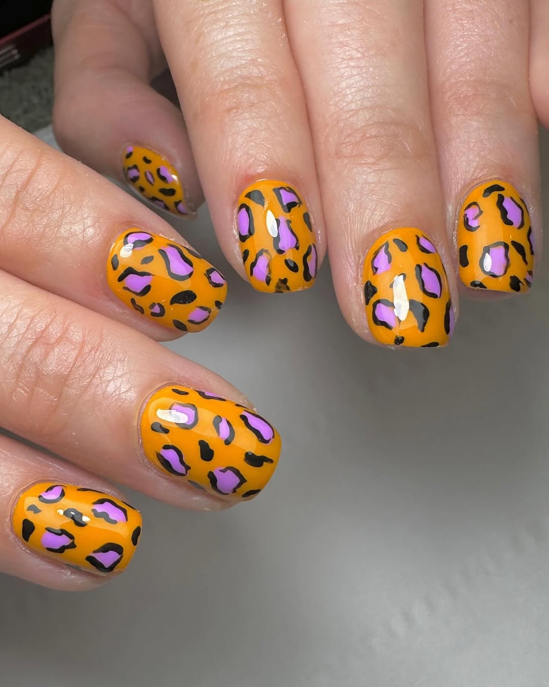 Vibrant Orange And Lilac Leopard Print Nails