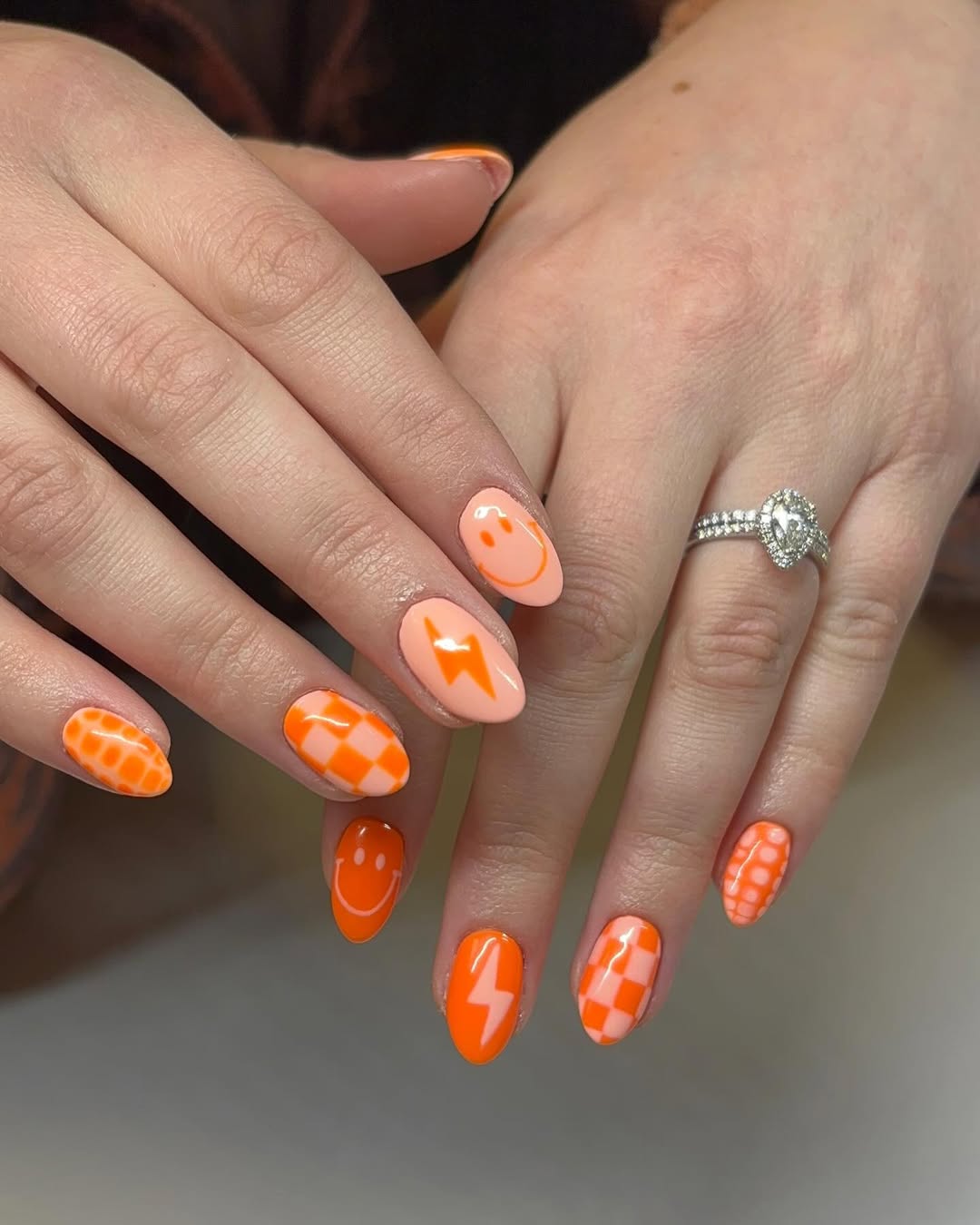 Vibrant Orange and Peach Smiley Lightning Checkered Nails