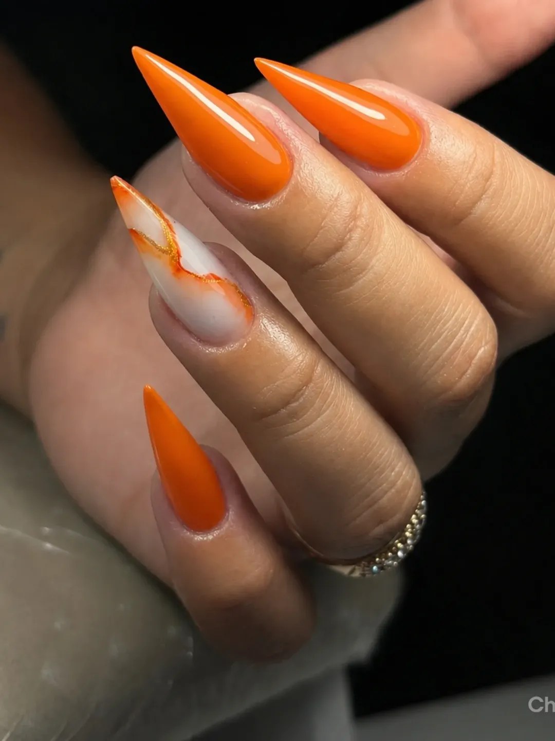 Vibrant Orange And White Marble Stiletto Nails