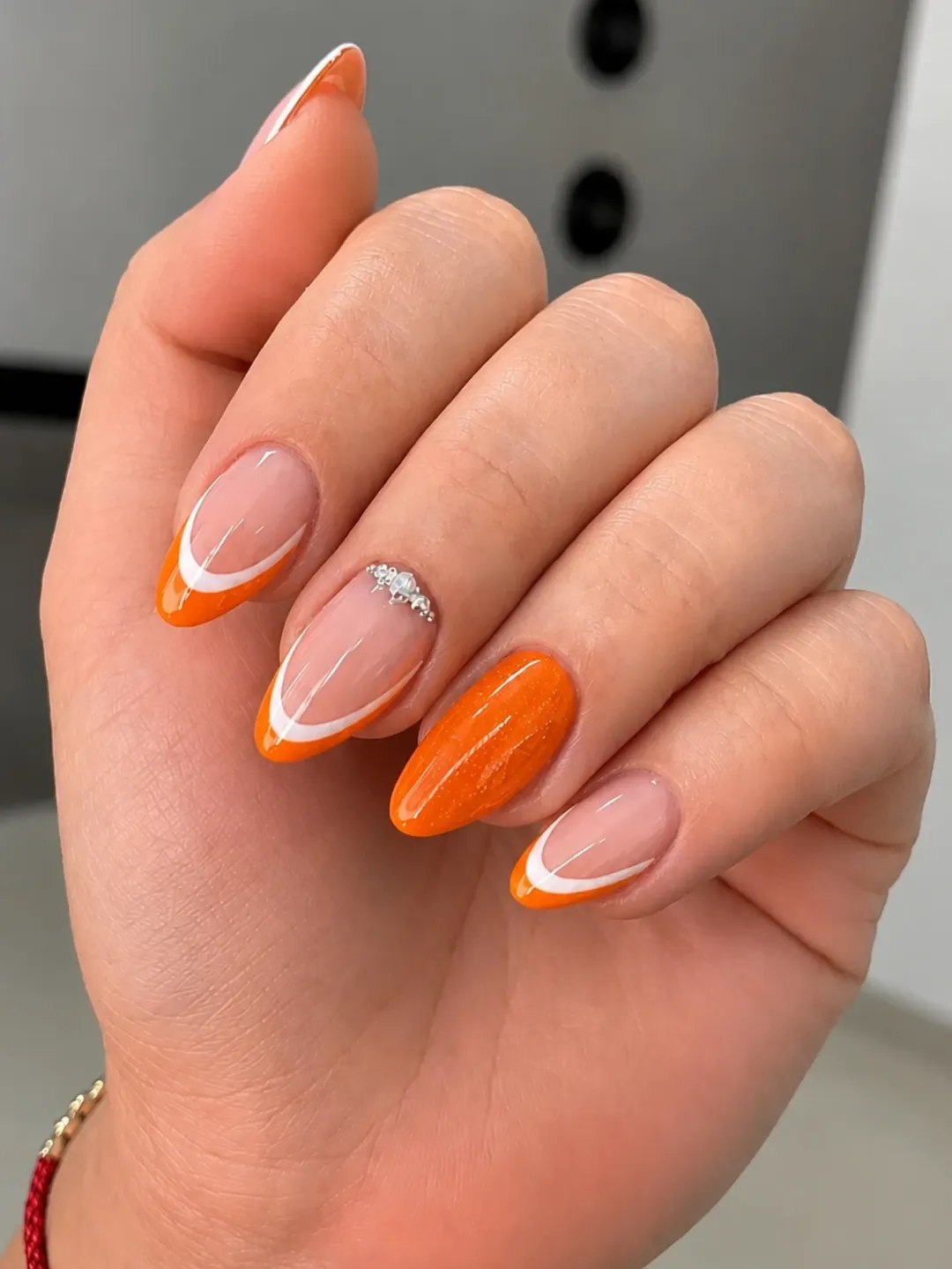 Vibrant Orange Glitter French Tips Almond Nails