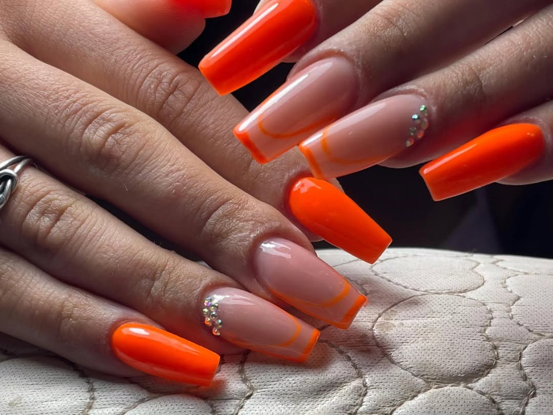 Vibrant Orange Tips And Rhinestone Accent Coffin Nails