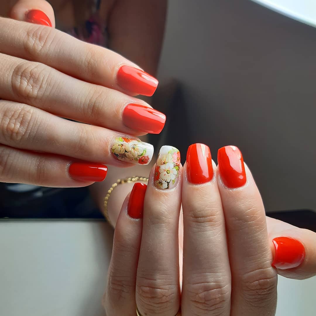 Vibrant Red Nails with Accent Floral Decals