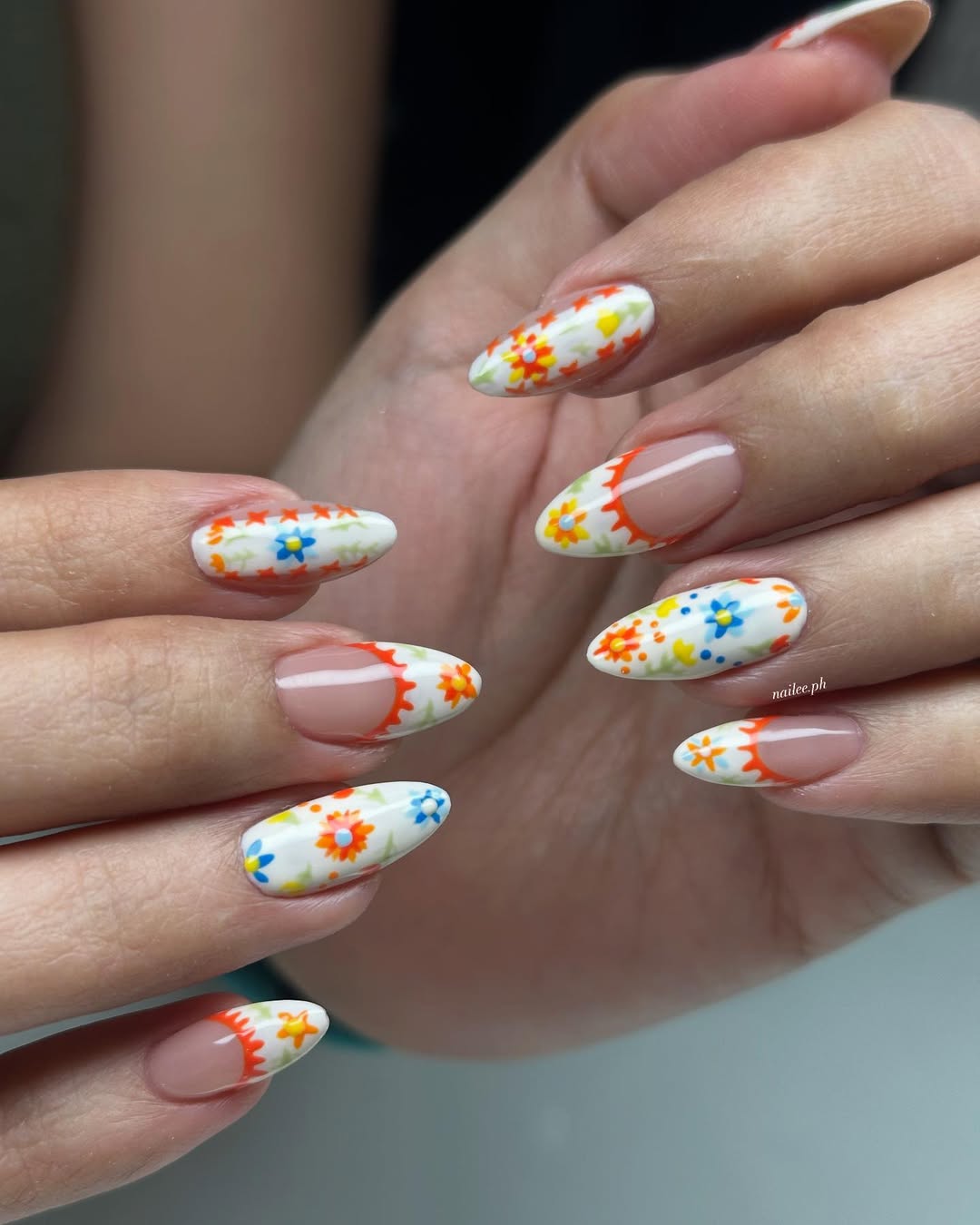 Whimsical Floral Orange French Almond Nails