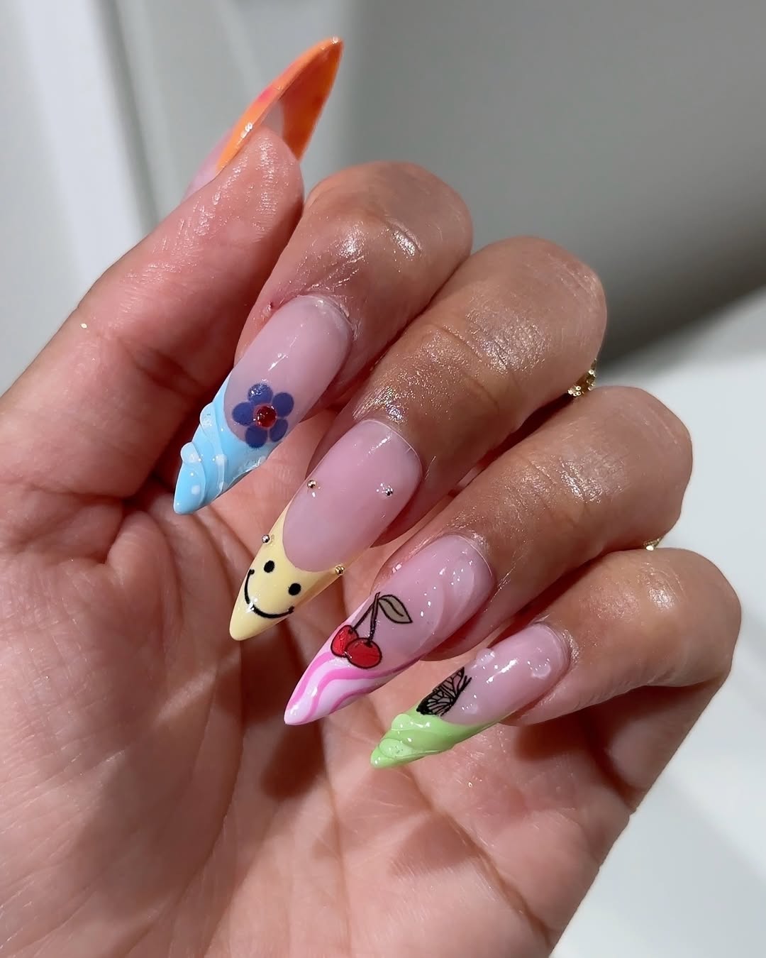 Whimsical Pastel Tipped Stiletto Nails with Fun Art