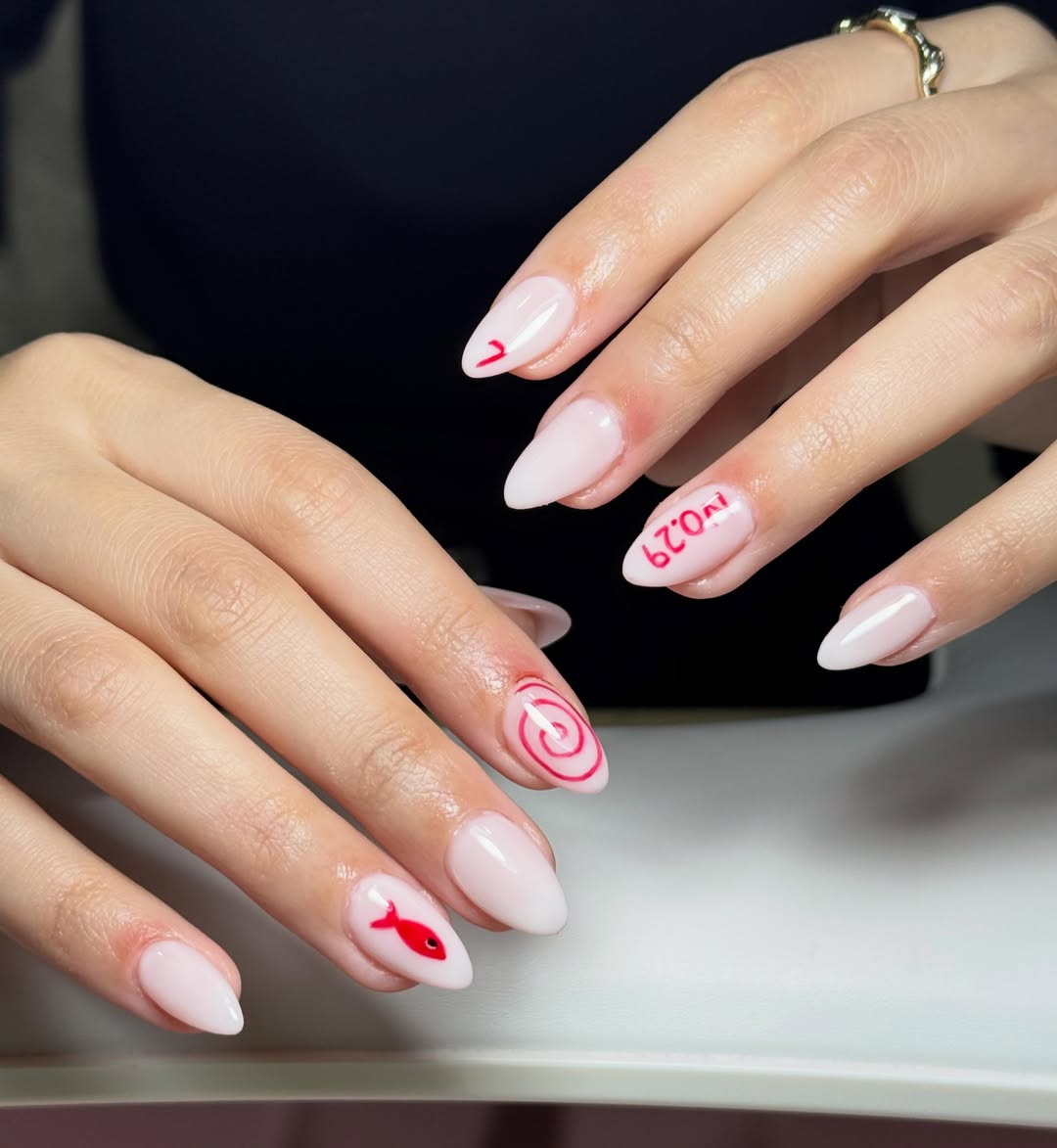 Whimsical Pink Almond Nails with Red Accents
