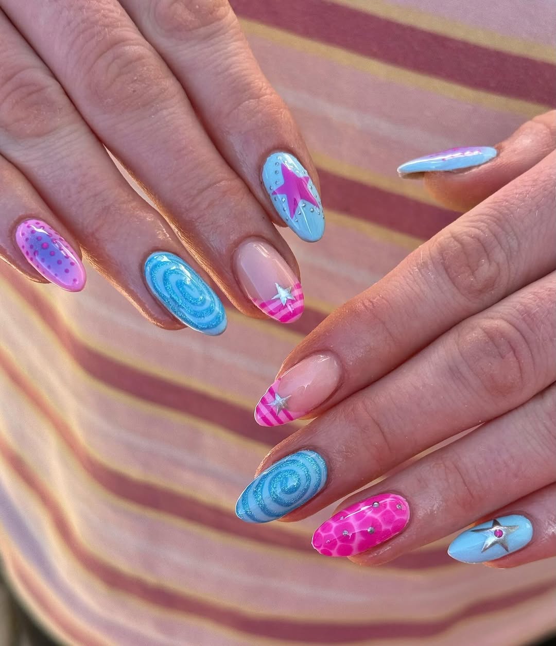 Whimsical Pink and Blue Swirls and Stars Almond Nails