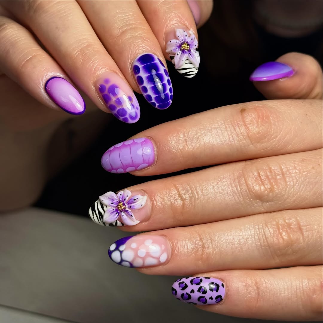 Whimsical Purple Patterned Nails with 3D Floral Accents
