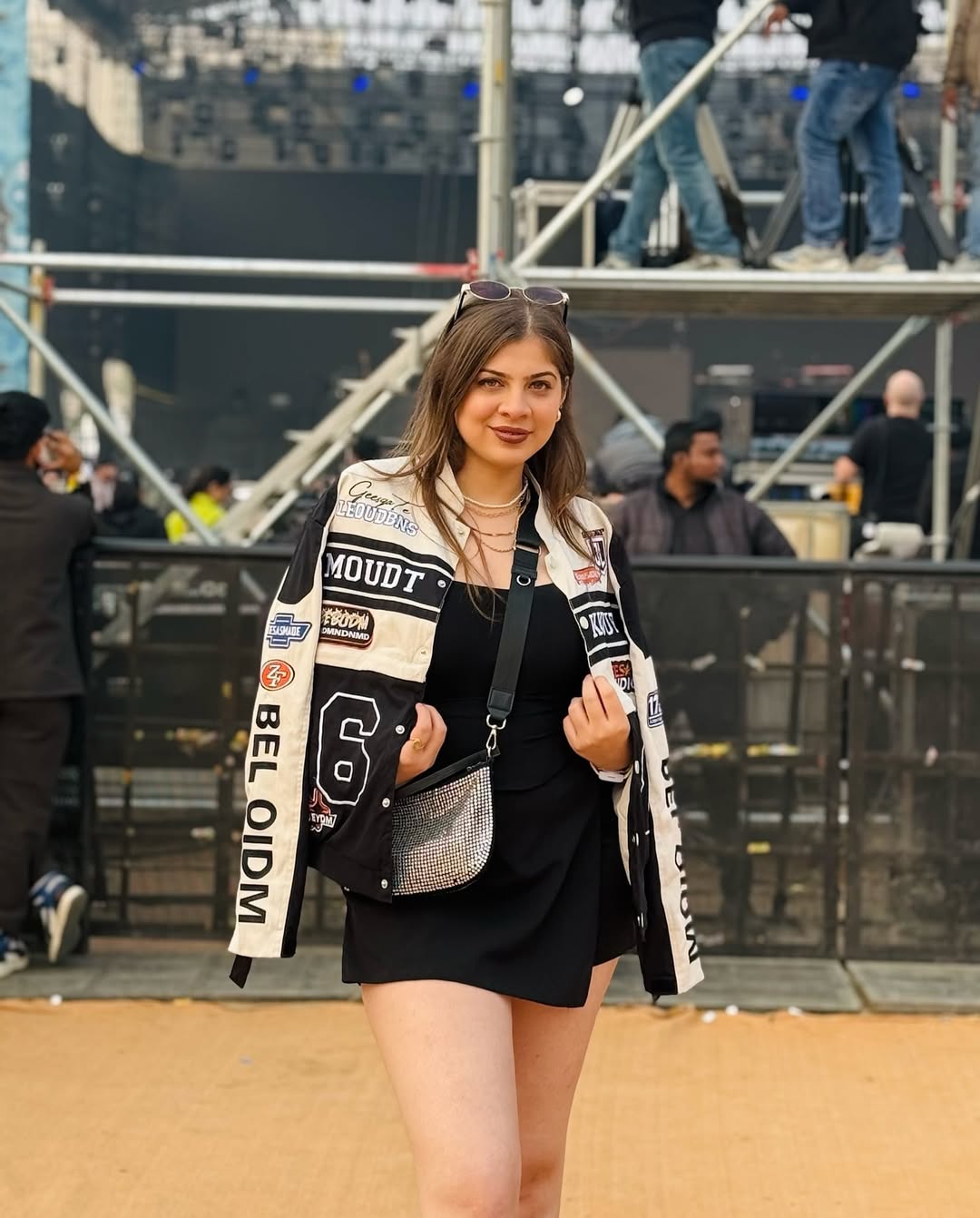 25 Concert Outfit Ideas You Need for 2026 8 Biker Jacket Over Black Mini Dress Concert Look