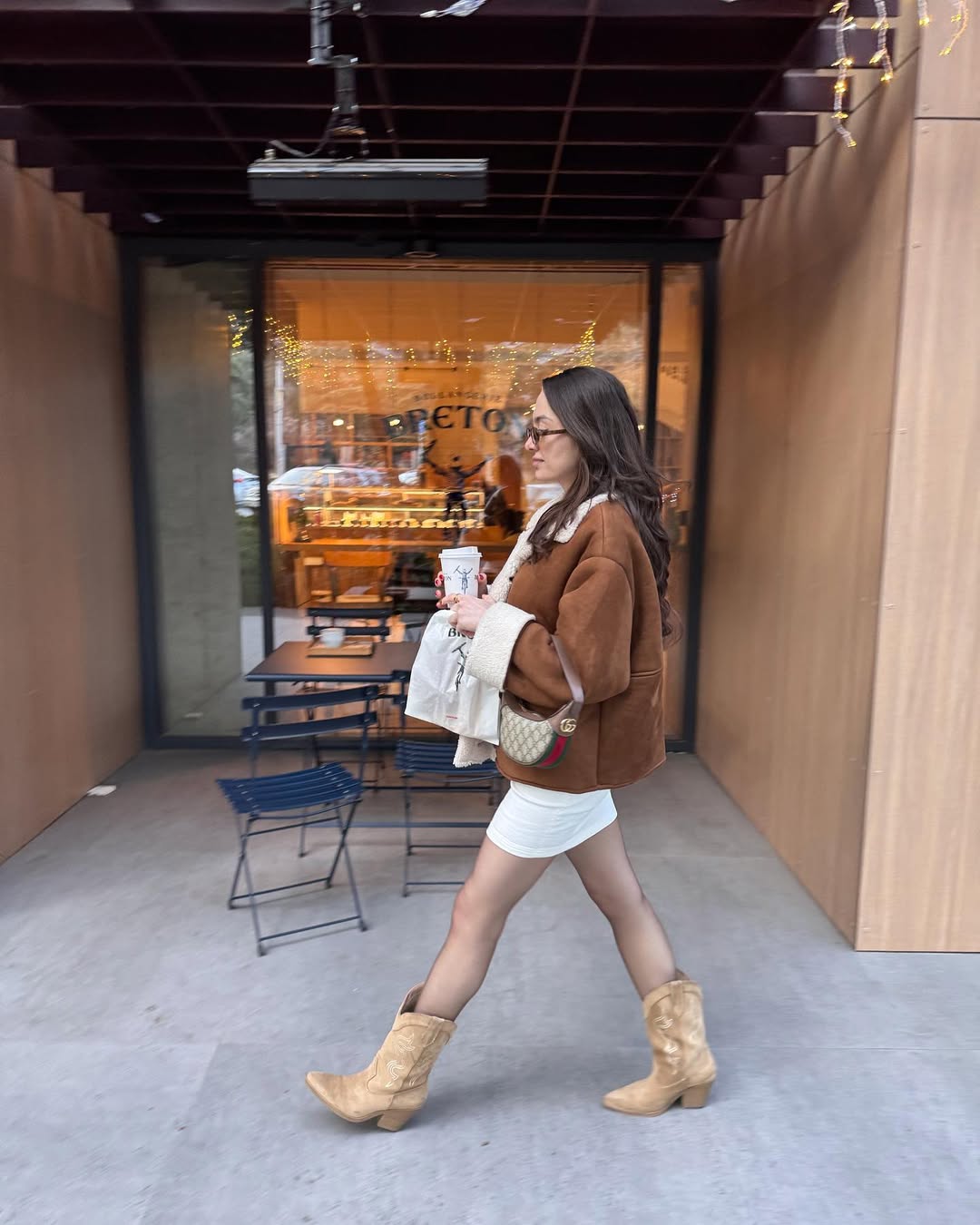 25 Cowboy Boot Outfits You Need for 2026 27 Brown Suede Shearling Jacket With White Mini Dress Cowboy Boots