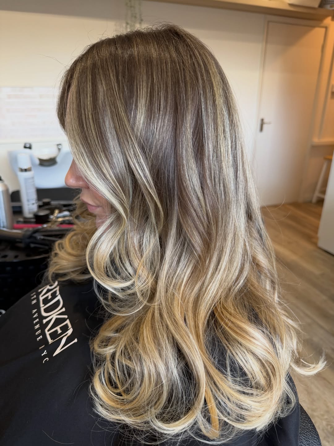 Caramel Blonde Face-Framing Layers With Wavy Finish