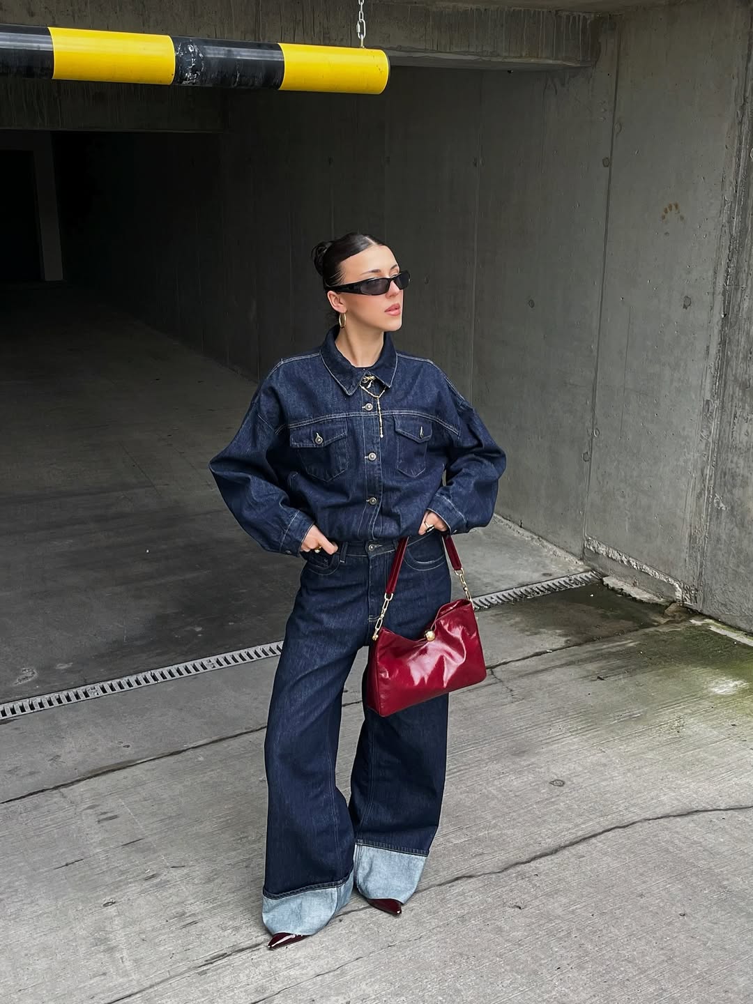 25 Denim on Denim Looks You Need for 2026 4 Dark Wash Denim Jumpsuit With Statement Red Bag