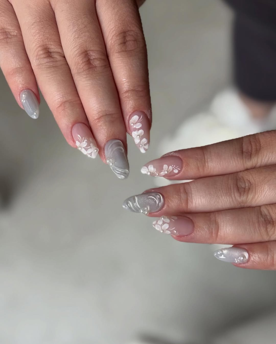 Delicate White Floral Almond Nails with Pearl Accents