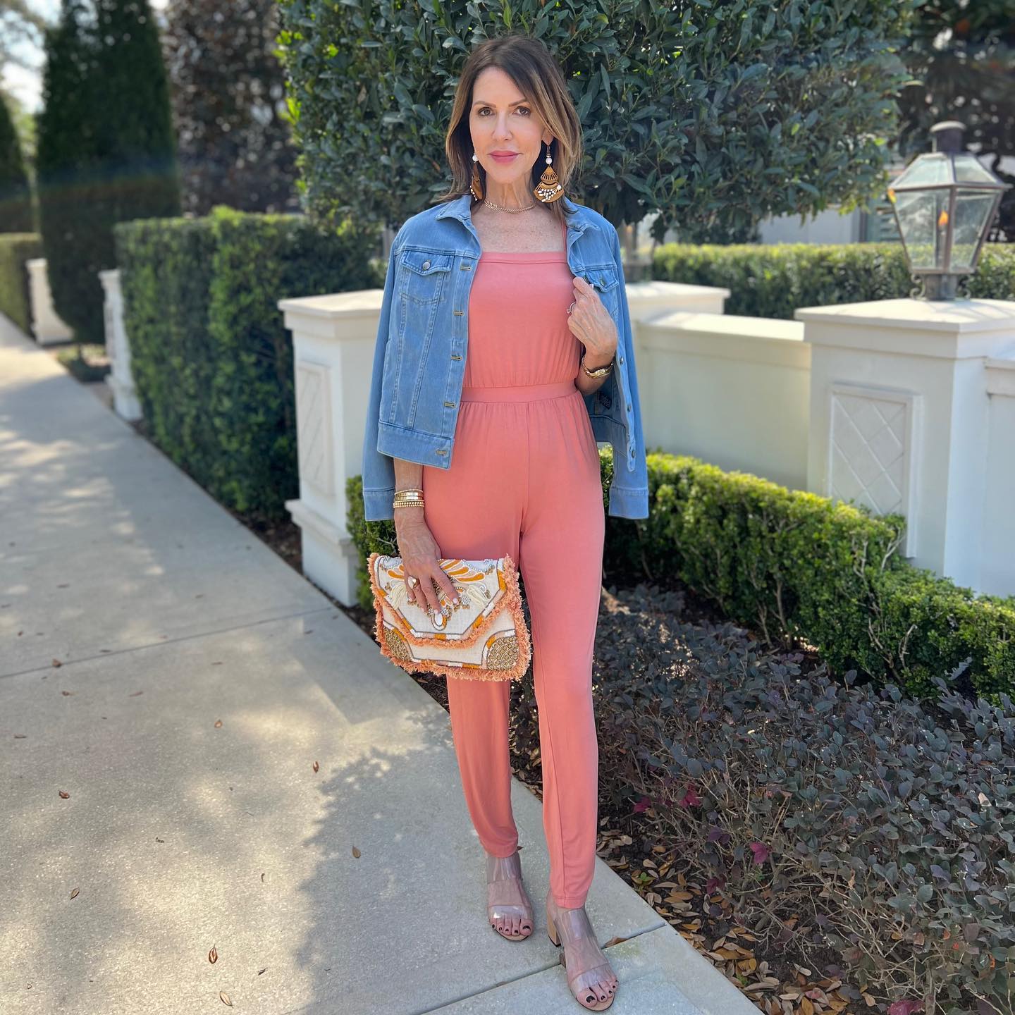 27 Jean Jacket Outfits You Need for 2026 15 Denim Jacket Over Coral Jumpsuit Casual Chic