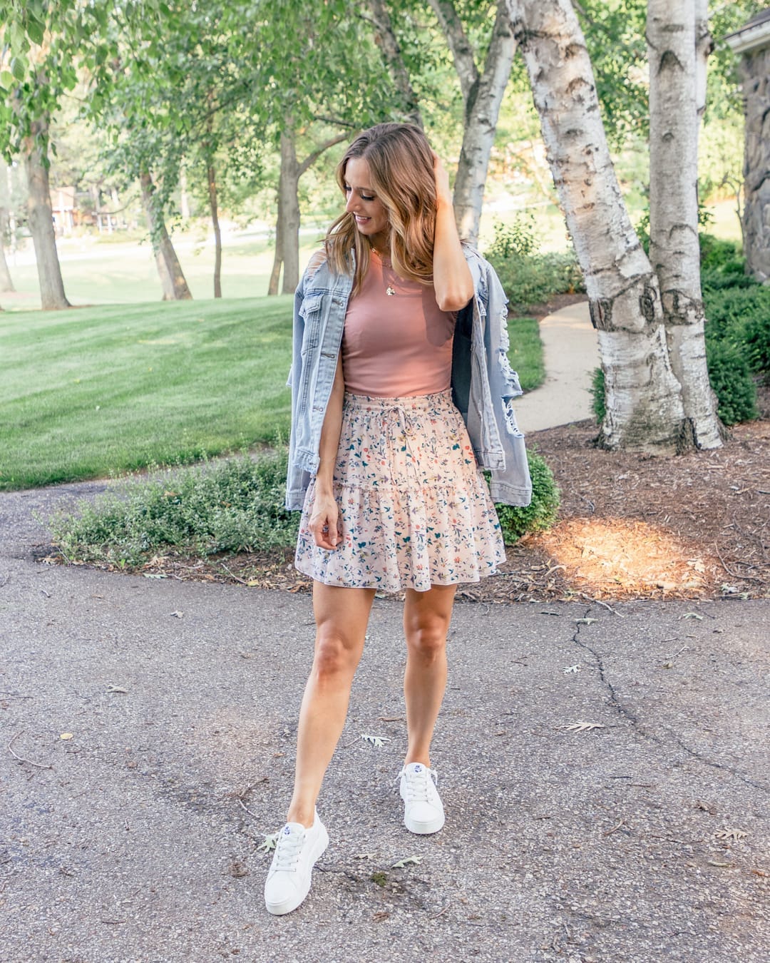 27 Jean Jacket Outfits You Need for 2026 26 Denim Jacket With Floral Mini Skirt And Sneakers