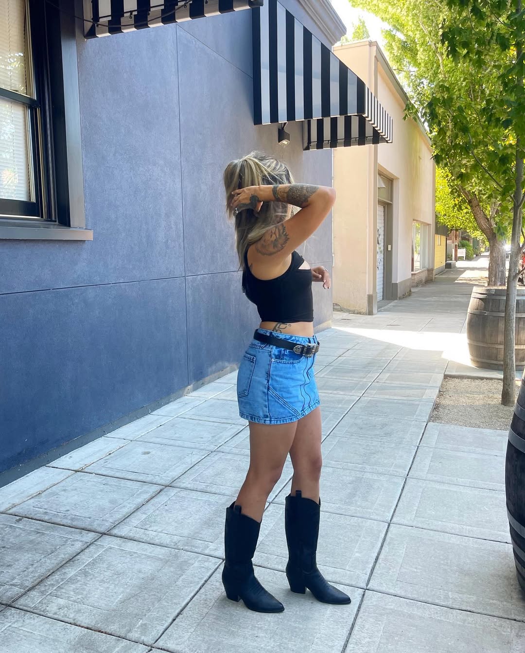 25 Cowboy Boot Outfits You Need for 2026 19 Denim Mini Skirt With Black Cowboy Boots