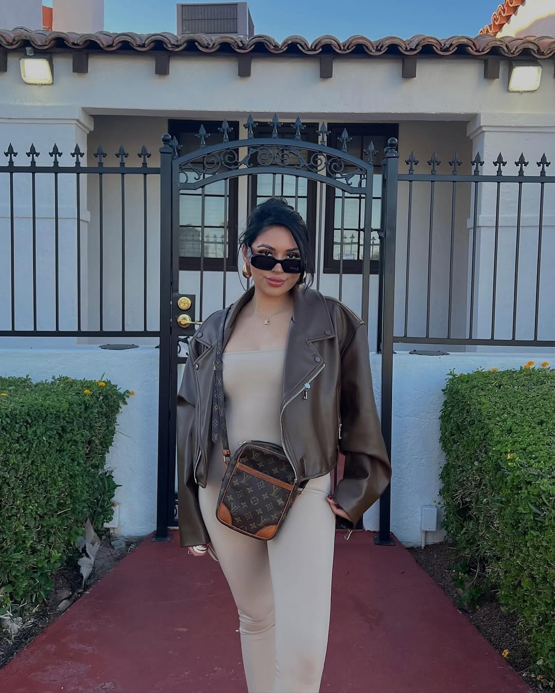 Faux Leather Moto Jacket Over Beige Bodysuit and Leggings
