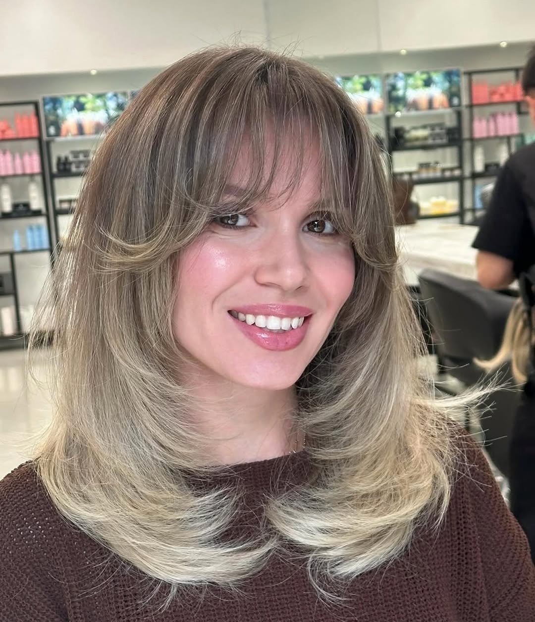 Feathered Layers With Bright Blonde Balayage Bangs