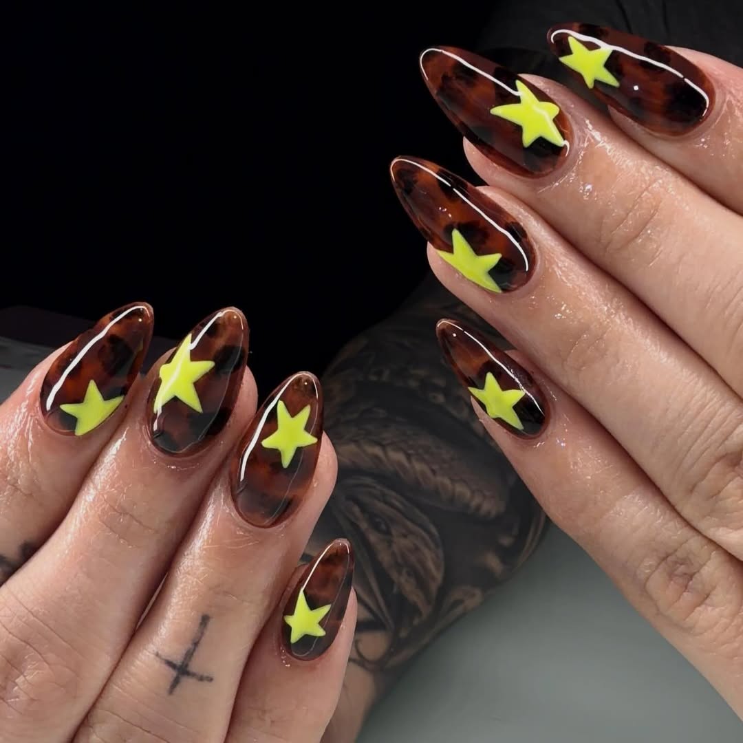 27 Tortoise Nail Trends You Need for 2026 21 Glossy Tortoise Shell Almond Nails With Yellow Stars