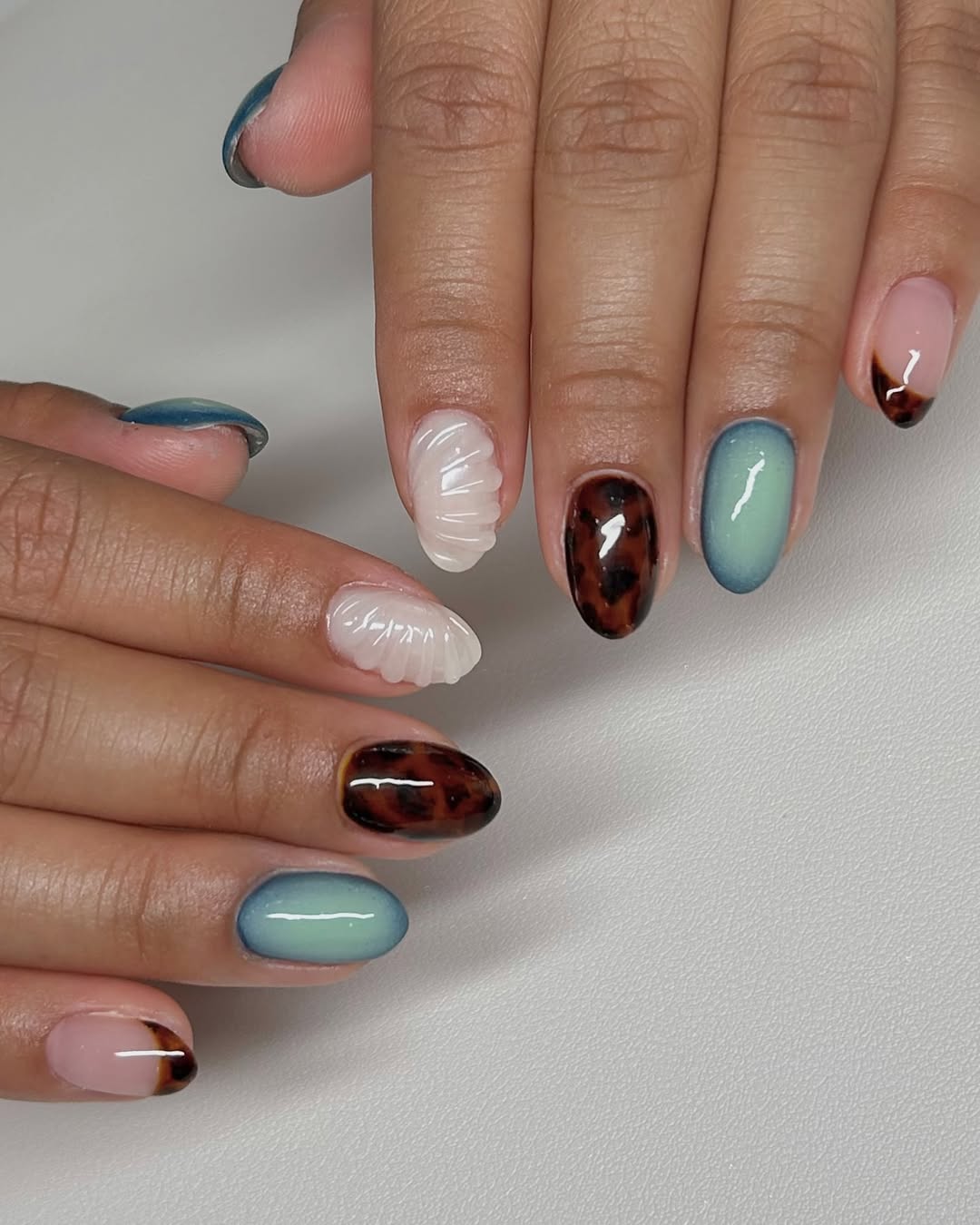 27 Tortoise Nail Trends You Need for 2026 22 Mixed Media Tortoise Shell Blue Jelly Seashell Nails