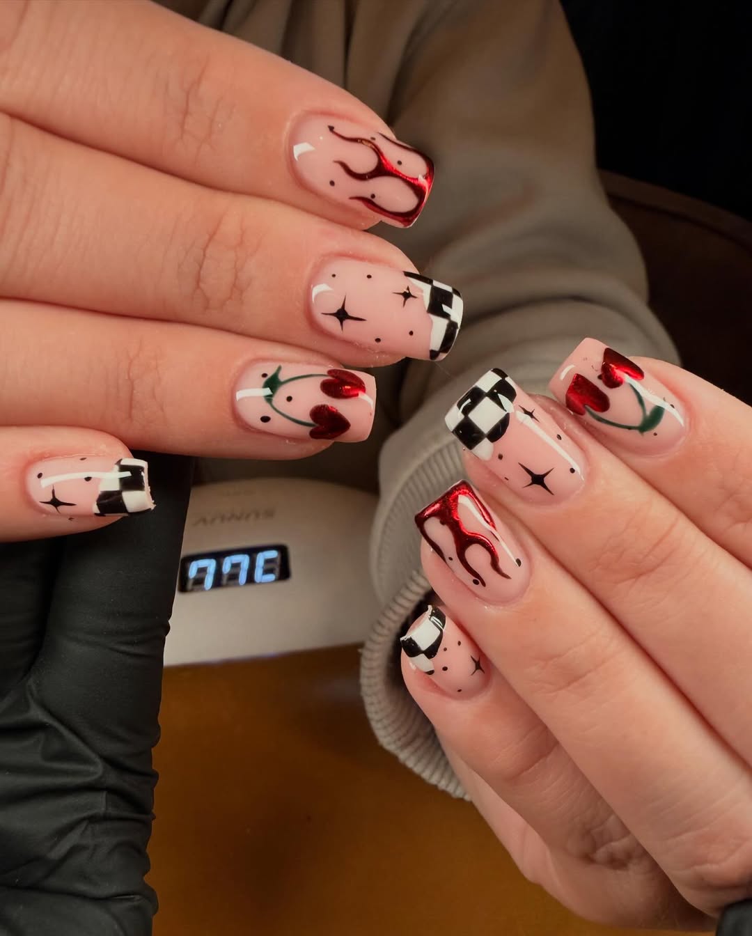 29 Checkerboard Nail Ideas for 2026 9 Nude Checkerboard Nails With Red Flames And Cherries