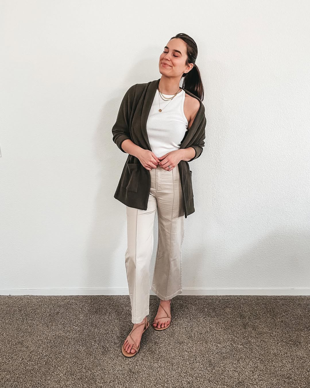 25 Fall Transition Outfits You Need for 2026 9 Olive Cardigan Over White Tank And Khaki Trousers