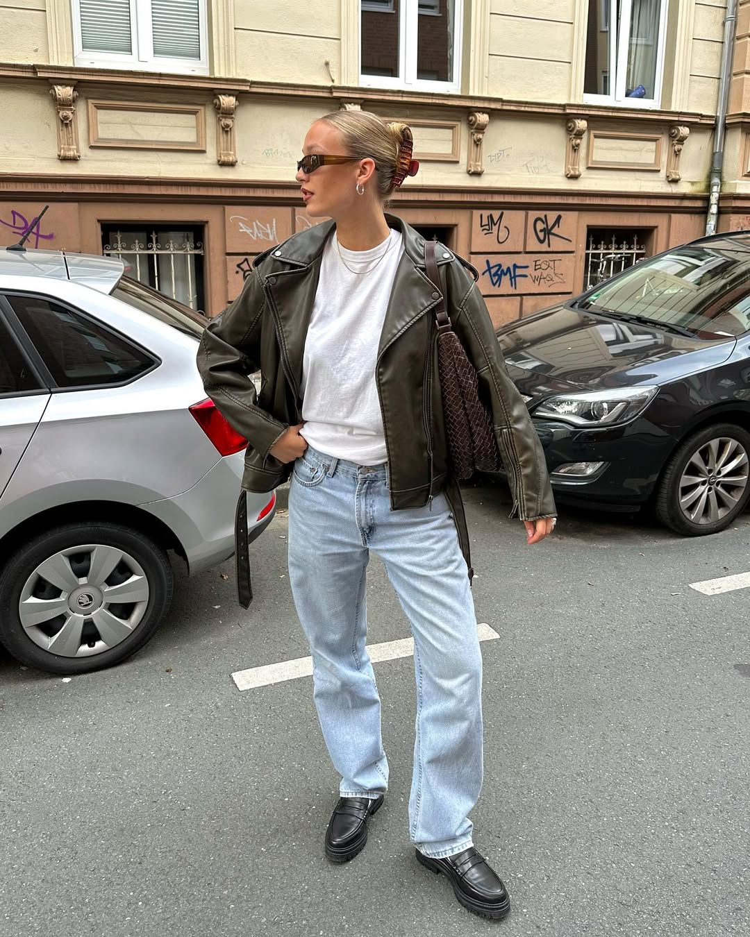 25 Fall Transition Outfits You Need for 2026 6 Olive Faux Leather Jacket With Light Wash Jeans