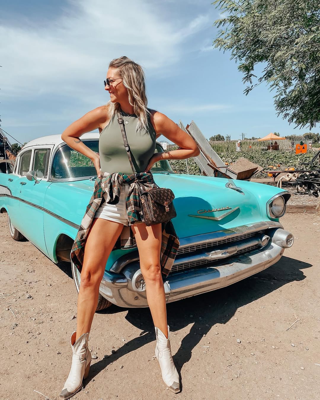 25 Cowboy Boot Outfits You Need for 2026 21 Olive Tank With White Cowboy Boots And Plaid