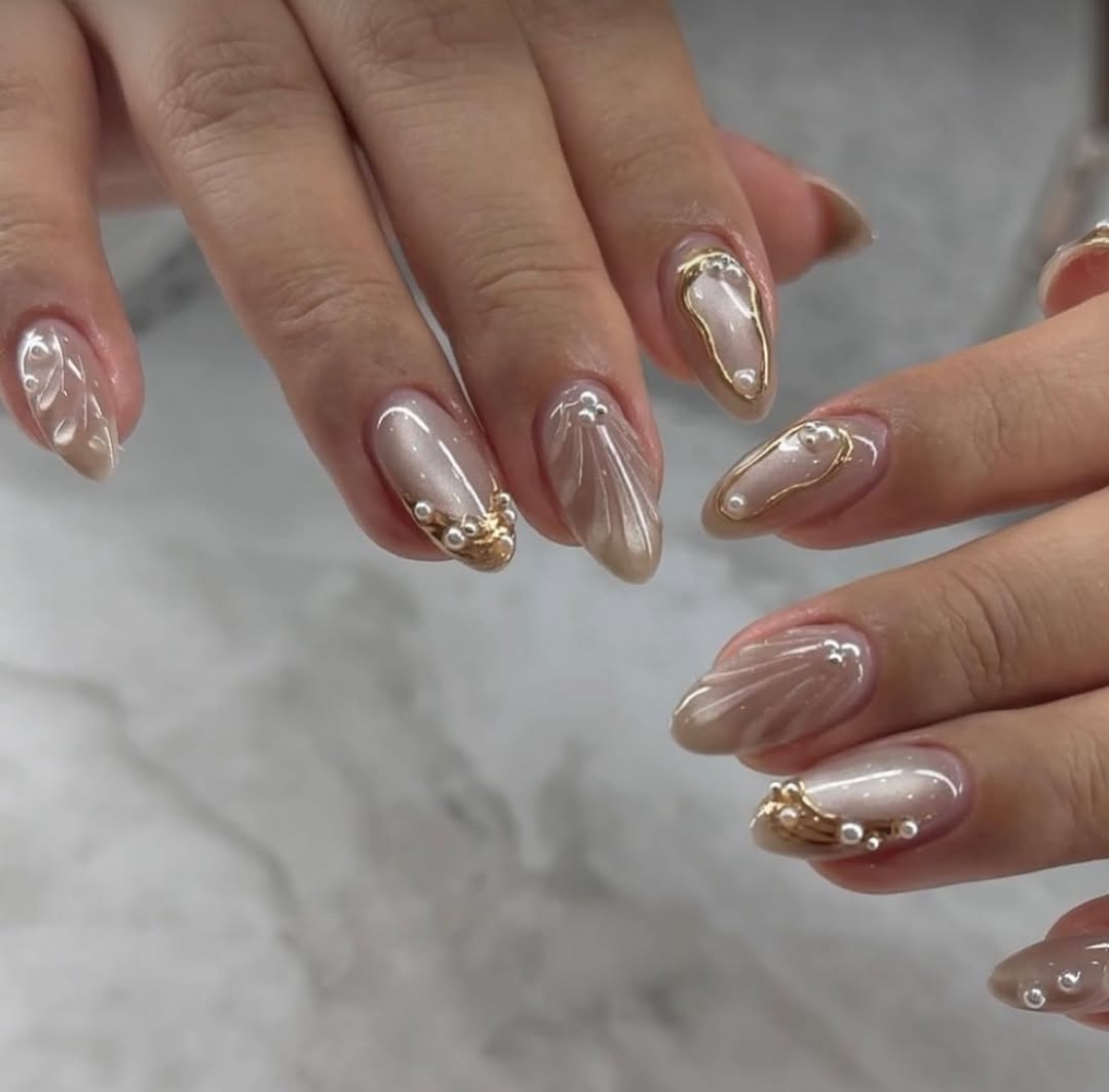 Opulent Champagne Shimmer Almond Nails with Pearl Accents