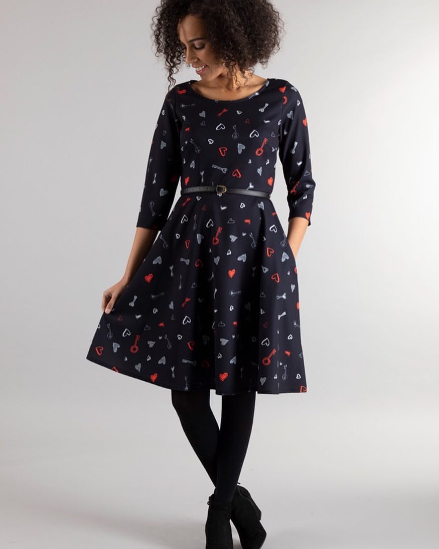 25 Dress with Tights Trends You Must See for 2026 14 Playful Printed A-Line Dress With Black Tights and Boots