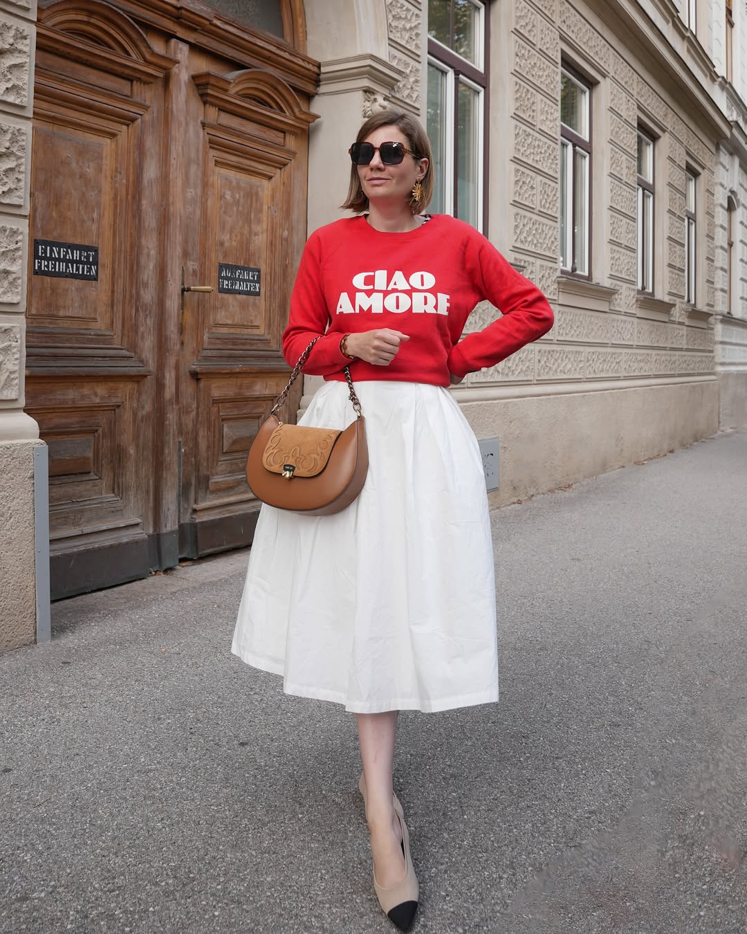 25 Fall Transition Outfits You Need for 2026 10 Red Graphic Sweatshirt With White Midi Skirt Outfit