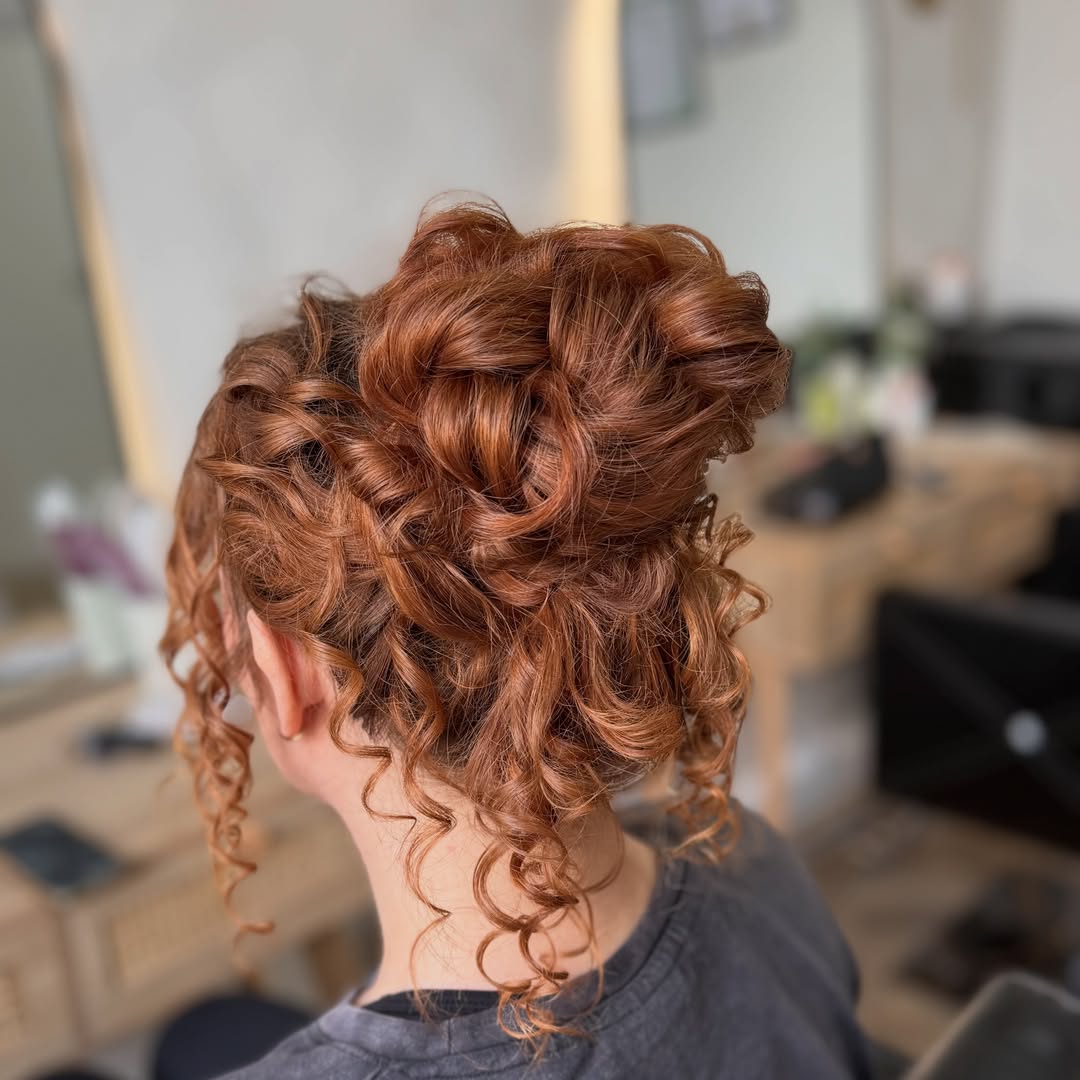 Relaxed Auburn Curly Updo With Face-Framing Tendrils