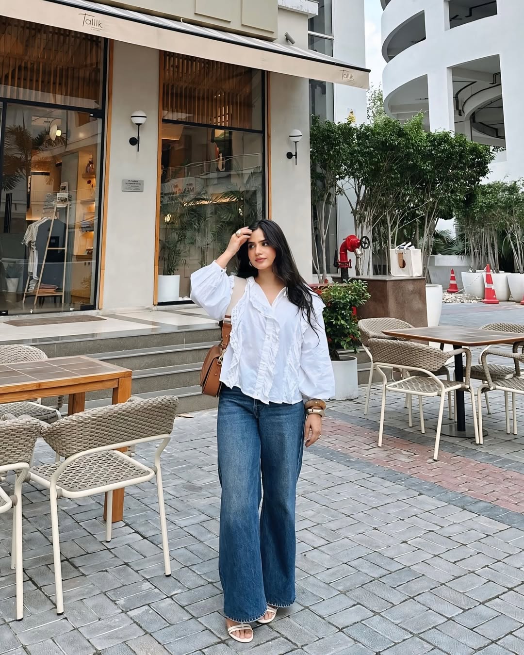 25 Concert Outfit Ideas You Need for 2026 26 Ruffled Blouse With Wide Leg Denim Look