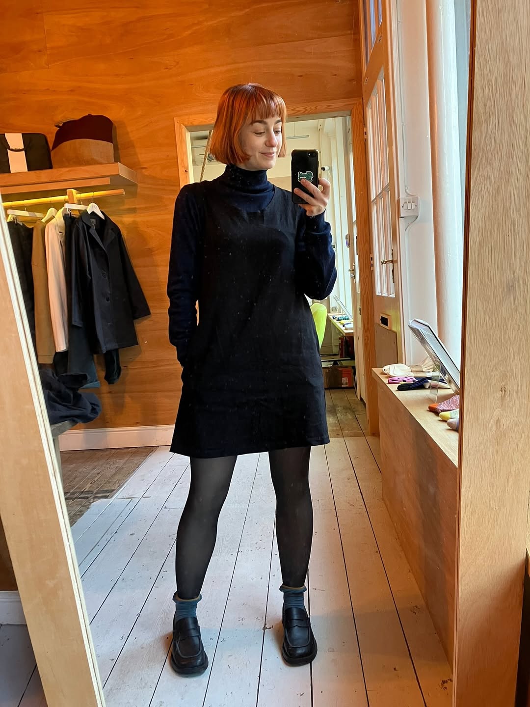 25 Dress with Tights Trends You Must See for 2026 10 Simple Black Pinafore Dress With Navy Turtleneck Layering