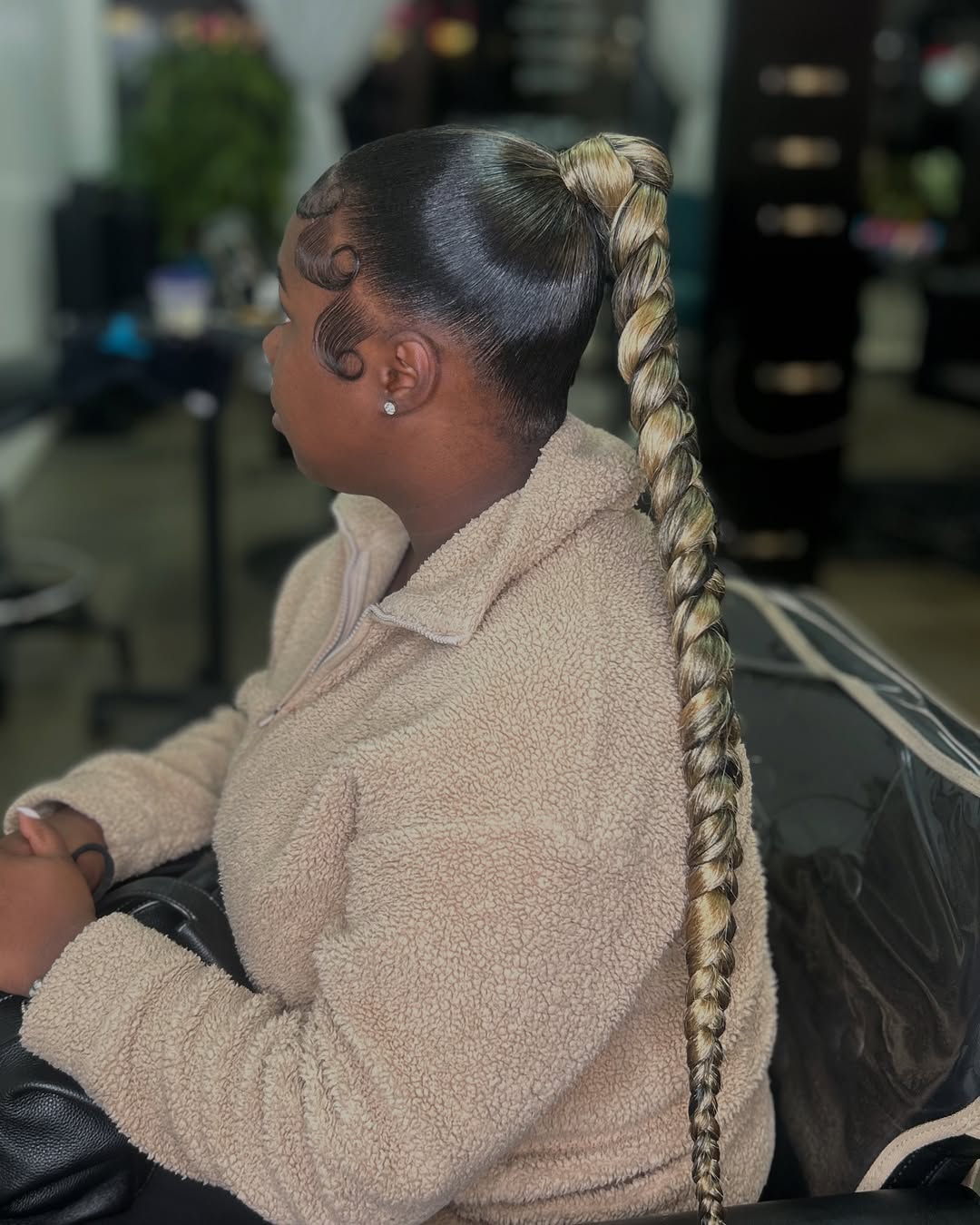 Sleek Braided Ponytail With Voluminous Curls
