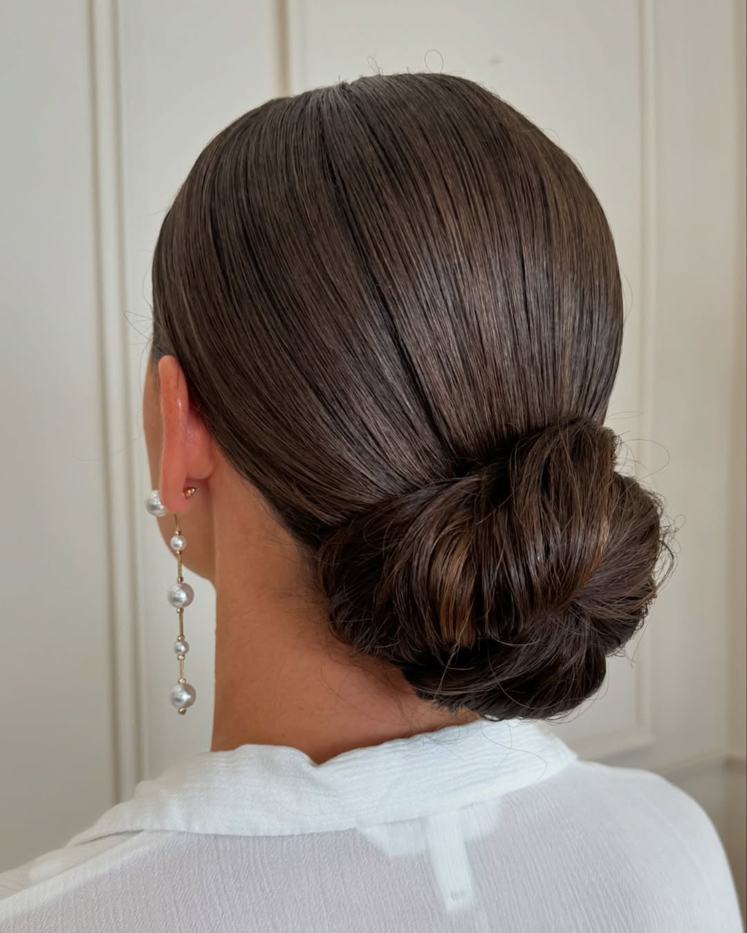 25 Sleek Hairstyles 2026 You Need To Try Now 20 Sleek Glossy Low Bun Chic Updo