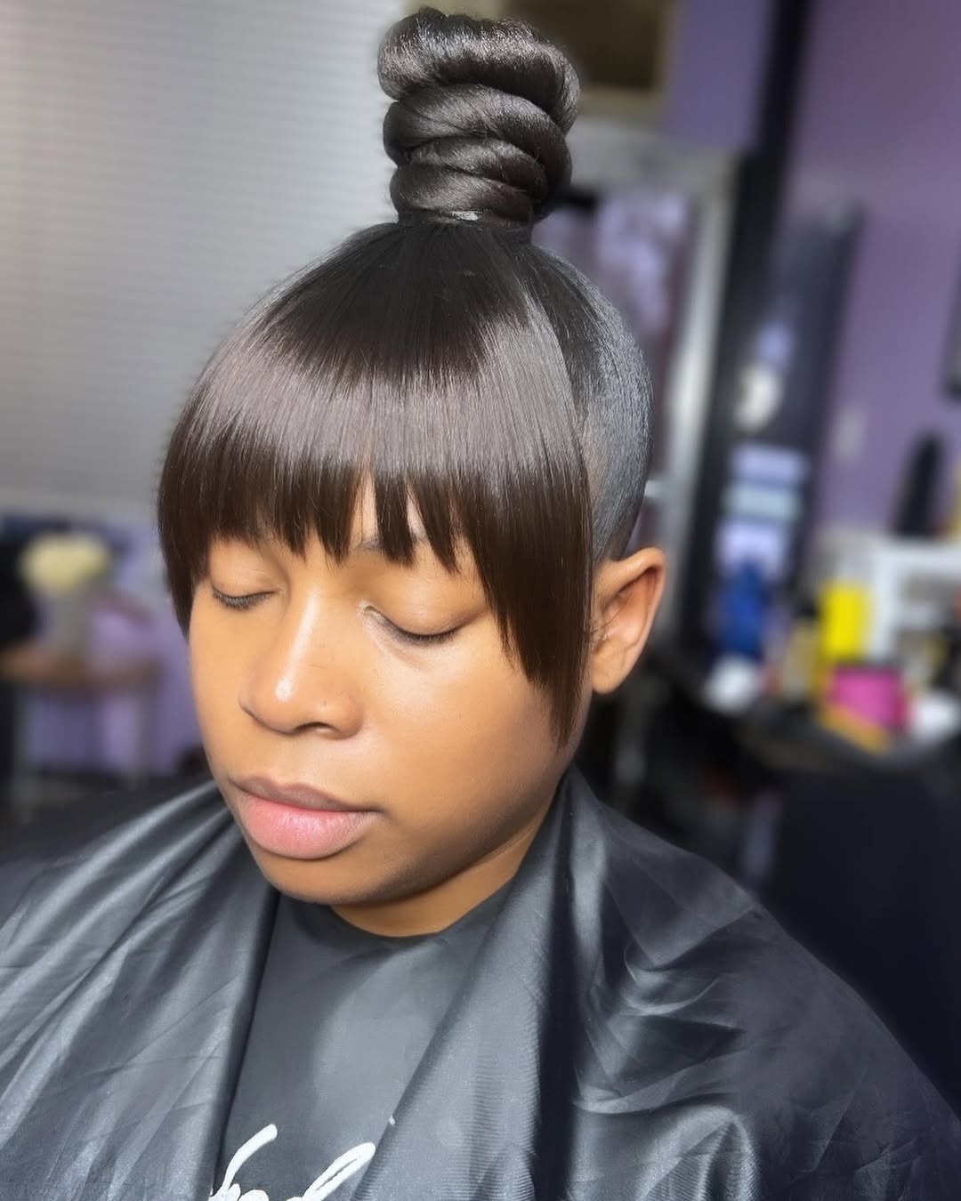 25 Sleek Hairstyles 2026 You Need To Try Now 25 Sleek High Bun With Curved Bangs