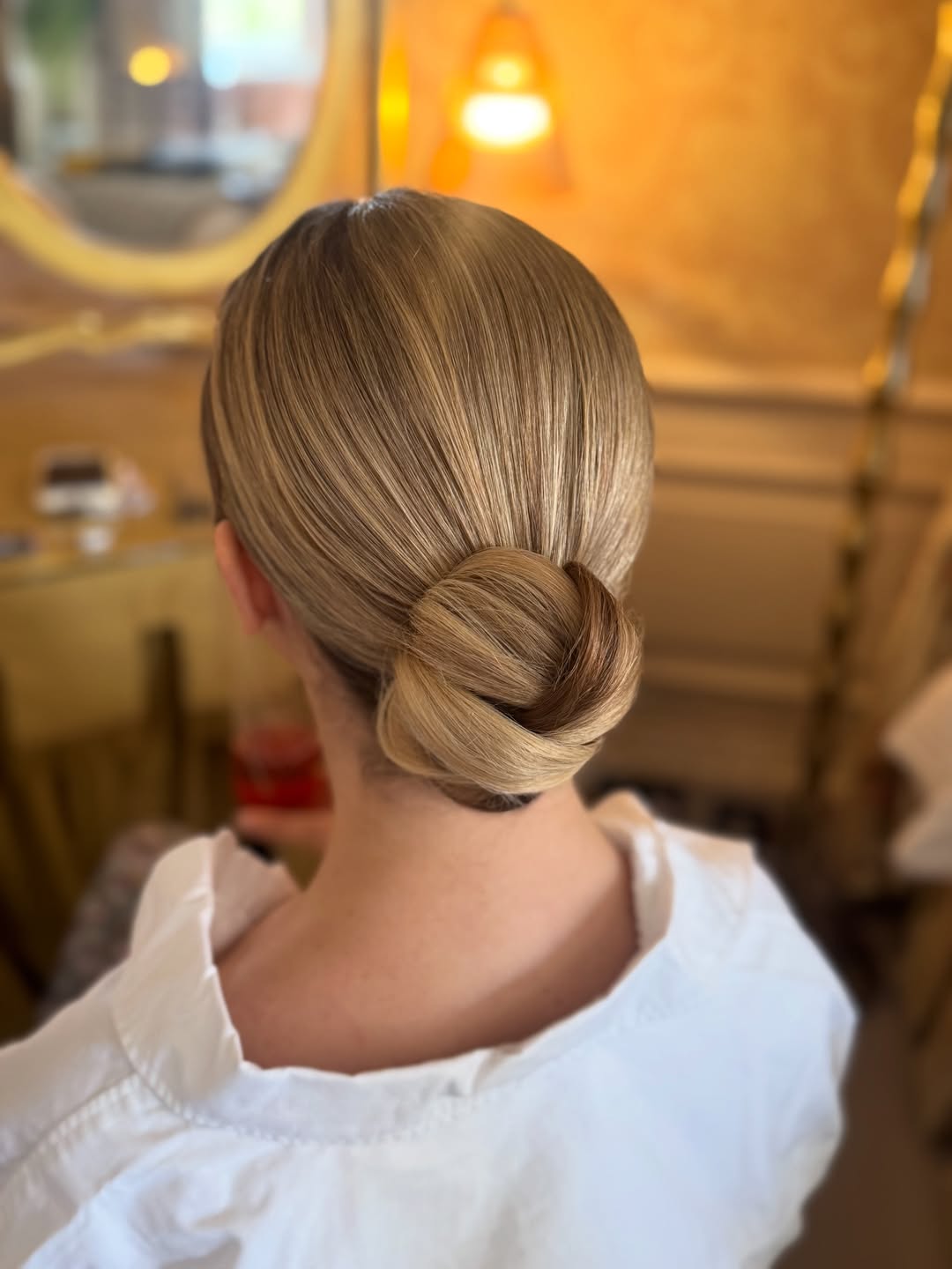 25 Sleek Hairstyles 2026 You Need To Try Now 8 Sleek Low Bun Golden Blonde Hair