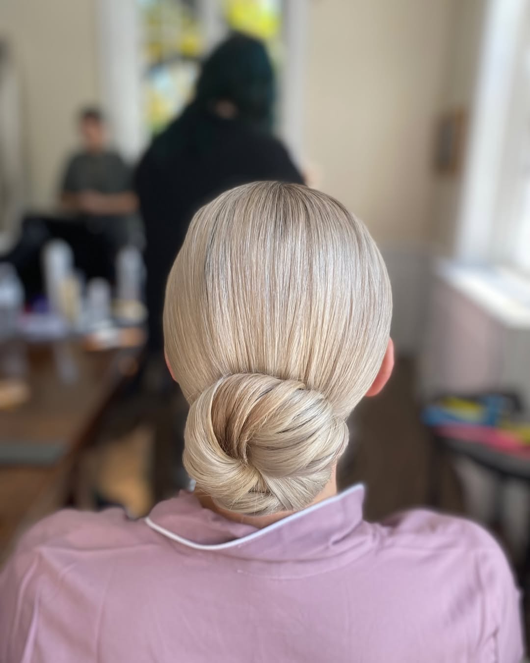 25 Sleek Hairstyles 2026 You Need To Try Now 3 Sleek Low Spiral Bun Platinum Blonde Updo
