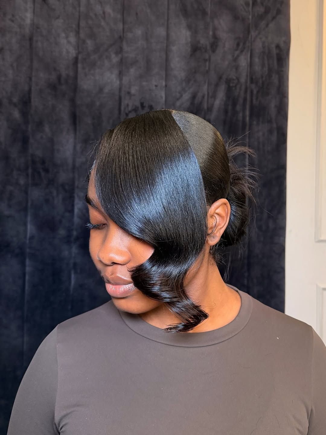 25 Sleek Hairstyles 2026 You Need To Try Now 15 Sleek Side-Swept Bangs With Low Bun