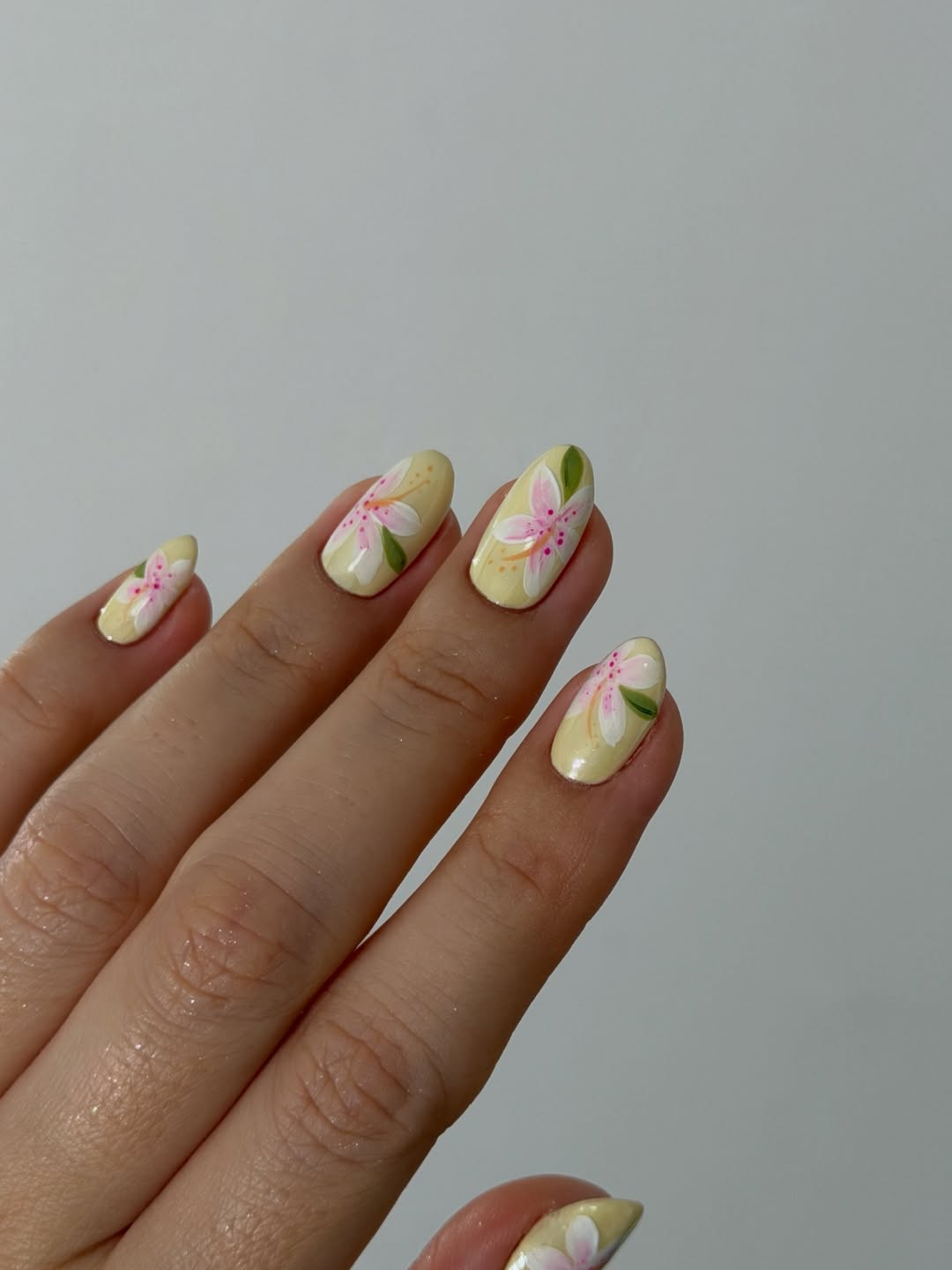 Soft Yellow Glossy Floral Hand-Painted Almond Nails
