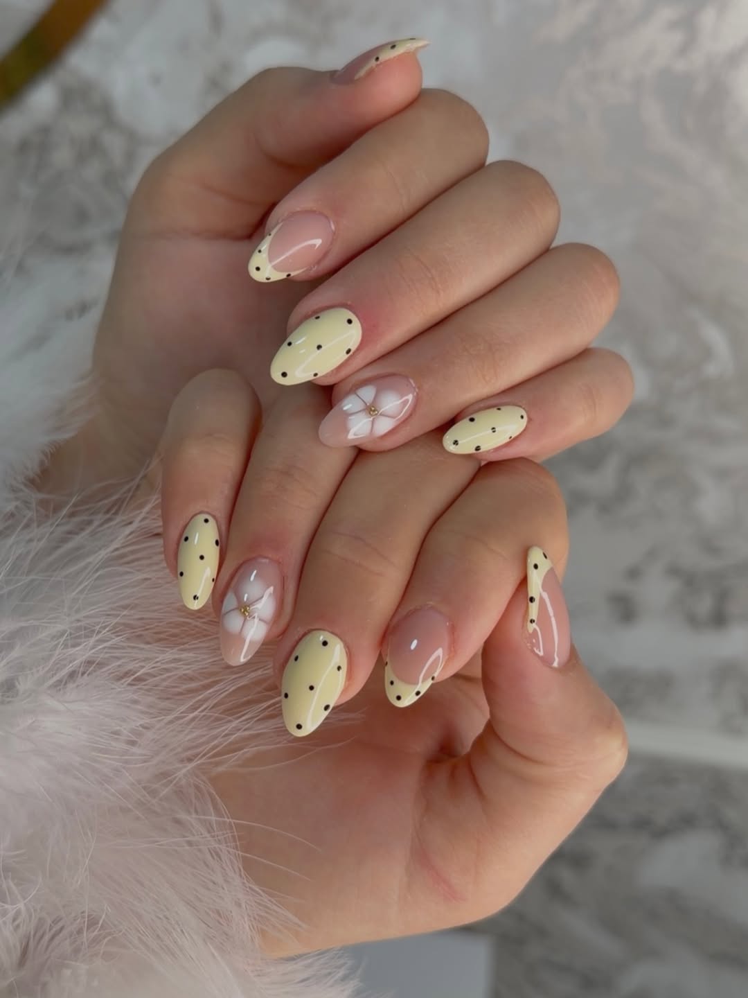 Soft Yellow Polka Dot French Tips with Floral Accent