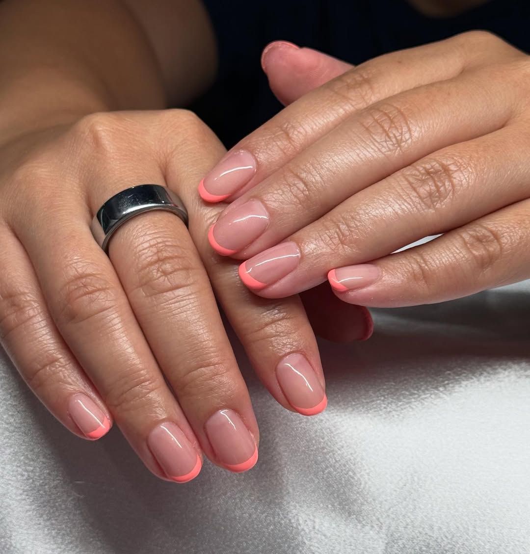 Vibrant Coral French Tips on Sheer Nude Base
