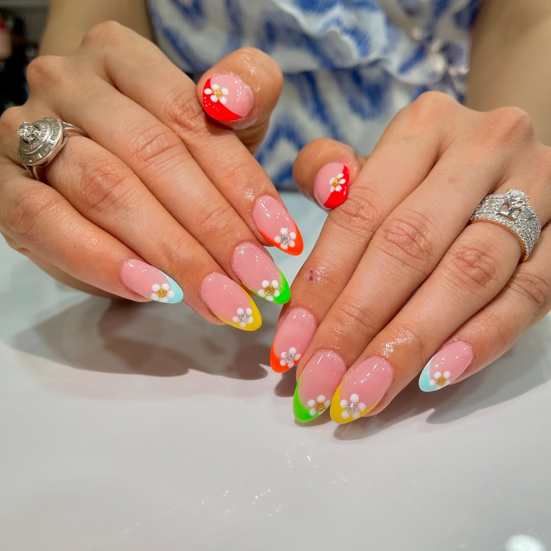 Vibrant Rainbow French Tips with Daisy Accents