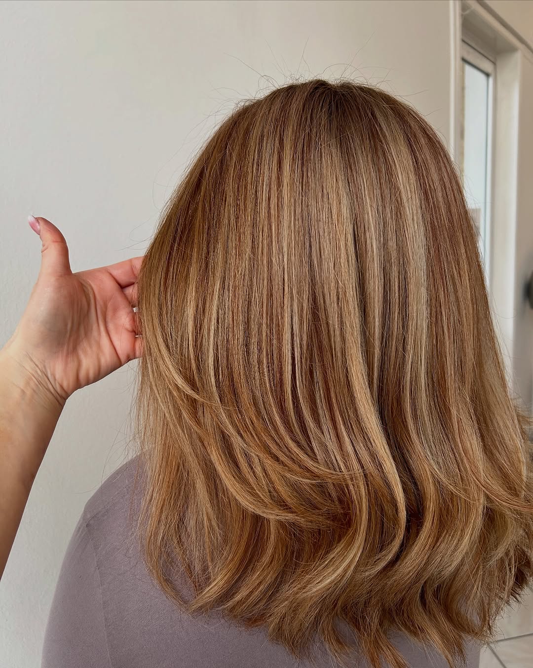 Warm Blonde Highlights On Caramel Wavy Layers