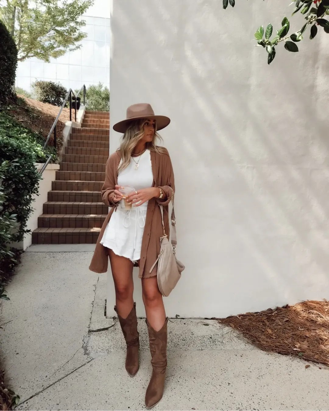 25 Cowboy Boot Outfits You Need for 2026 15 White Mini Dress With Cowboy Boots And Fedora